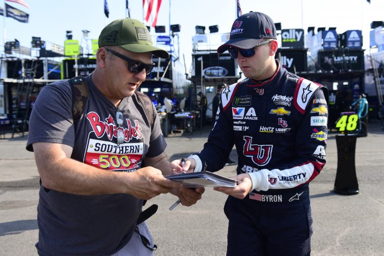 LONG POND, PENNSYLVANIA - JULY 27: William Byron, driver of the #24 Liberty University Chevrolet, signs an autograph for a fan during practice for the Monster Energy NASCAR Cup Series Gander RV 400 at Pocono Raceway on July 27, 2019 in Long Pond, Pennsylvania. (Photo by Jared C. Tilton/Getty Images) | Getty Images