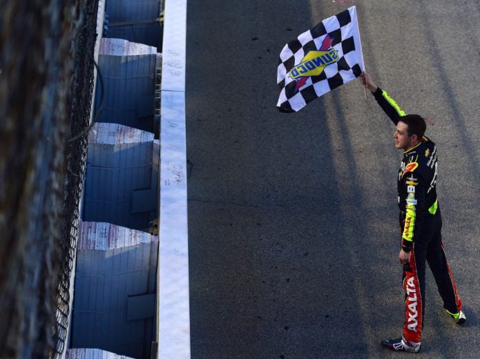 JOLIET, ILLINOIS - JUNE 30: Alex Bowman, driver of the #88 Axalta Chevrolet, celebrates with the checkered flag after winning the Monster Energy NASCAR Cup Series Camping World 400 at Chicagoland Speedway on June 30, 2019 in Joliet, Illinois. (Photo by Jared C. Tilton/Getty Images) | Getty Images