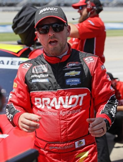 JOLIET, ILLINOIS - JUNE 29: Justin Allgaier, driver of the #7 BRANDT Professional Agriculture Chevrolet, talks with crew members after qualifying for the NASCAR Xfinity Series Camping World 300 at Chicagoland Speedway on June 29, 2019 in Joliet, Illinois. (Photo by Jonathan Daniel/Getty Images) | Getty Images
