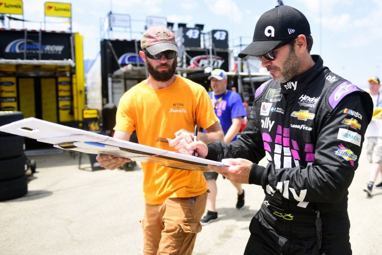 JOLIET, ILLINOIS - JUNE 29: Jimmie Johnson, driver of the #48 Ally Chevrolet, signs an autograph for a fan during practice for the Monster Energy NASCAR Cup Series Camping World 400 at Chicagoland Speedway on June 29, 2019 in Joliet, Illinois. (Photo by Jared C. Tilton/Getty Images) | Getty Images