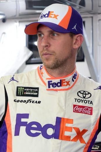 LONG POND, PENNSYLVANIA - MAY 31: Denny Hamlin, driver of the #11 FedEx Office Toyota, stands in the garage area during practice for the Monster Energy NASCAR Cup Series Pocono 400 at Pocono Raceway on May 31, 2019 in Long Pond, Pennsylvania. (Photo by Jared C. Tilton/Getty Images) | Getty Images