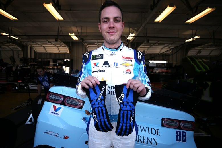 SPARTA, KENTUCKY - JULY 12: Alex Bowman, driver of the #88 Nationwide Children's Hospital Chevrolet, poses with his gloves during practice for the Monster Energy NASCAR Cup Series Quaker State 400 Presented by Walmart at Kentucky Speedway on July 12, 2019 in Sparta, Kentucky. (Photo by Matt Sullivan/Getty Images) | Getty Images