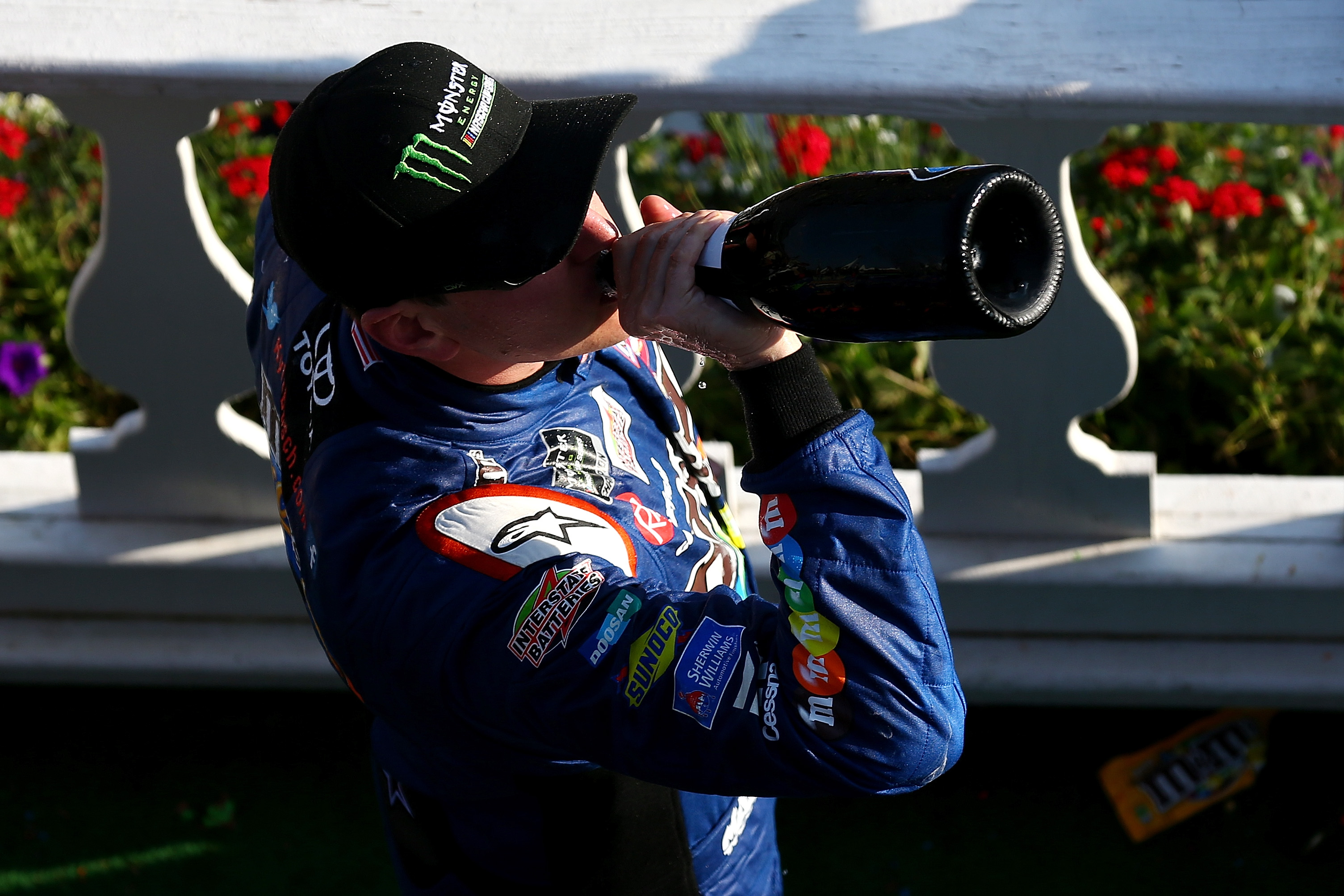 LONG POND, PA - JULY 29:  Kyle Busch, driver of the #18 M&M's Caramel Toyota, celebrates with champagne in Victory Lane after winning the Monster Energy NASCAR Cup Series Gander Outdoors 400 at Pocono Raceway on July 29, 2018 in Long Pond, Pennsylvania.  (Photo by Sarah Crabill/Getty Images) | Getty Images