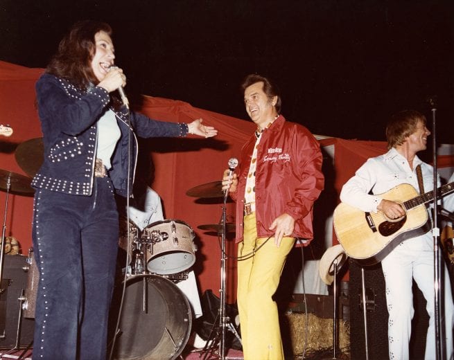 CHARLOTTE, NC - 1975:  Charlotte Motor Speedway has always been known for bringing in top entertainment for the fans prior to races. Here country & western superstars Loretta Lynn and Conway Twitty perform for the crowd prior to a NASCAR event. (Photo by ISC Images & Archives via Getty Images)