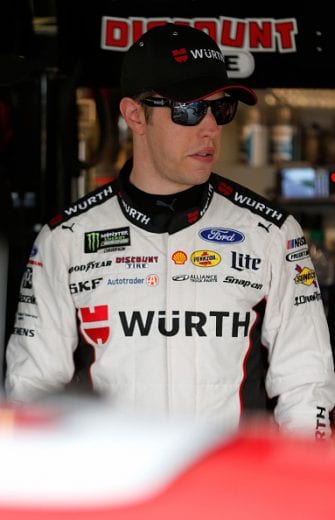 KANSAS CITY, KS - MAY 10: Brad Keselowski, driver of the #2 Wurth Ford, stands in the garage during practice for the Monster Energy NASCAR Cup Series Digital Ally 400 at Kansas Speedway on May 10, 2019 in Kansas City, Kansas. (Photo by Brian Lawdermilk/Getty Images) | Getty Images