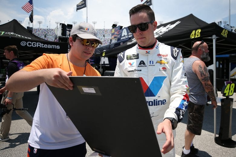 DAYTONA BEACH, FLORIDA - JULY 04: Alex Bowman, driver of the #88 Valvoline Patriotic Chevrolet, signs autographs during practice for the Monster Energy NASCAR Cup Series Coke Zero Sugar 400 at Daytona International Speedway on July 04, 2019 in Daytona Beach, Florida. (Photo by Matt Sullivan/Getty Images) | Getty Images