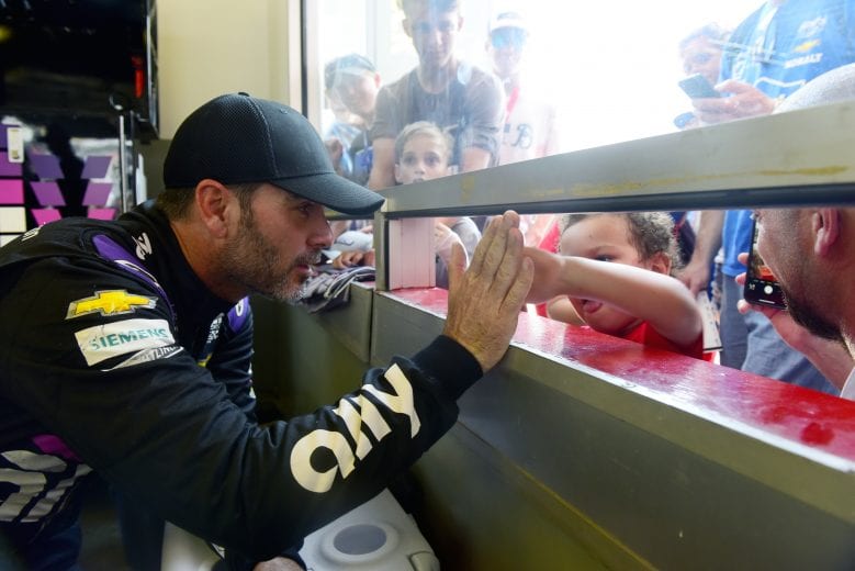 DAYTONA BEACH, FLORIDA - JULY 04: Jimmie Johnson, driver of the #48 Ally Chevrolet, signs autographs for fans in the garage area during practice for the Monster Energy NASCAR Cup Series Coke Zero Sugar 400 at Daytona International Speedway on July 04, 2019 in Daytona Beach, Florida. (Photo by Jared C. Tilton/Getty Images) | Getty Images