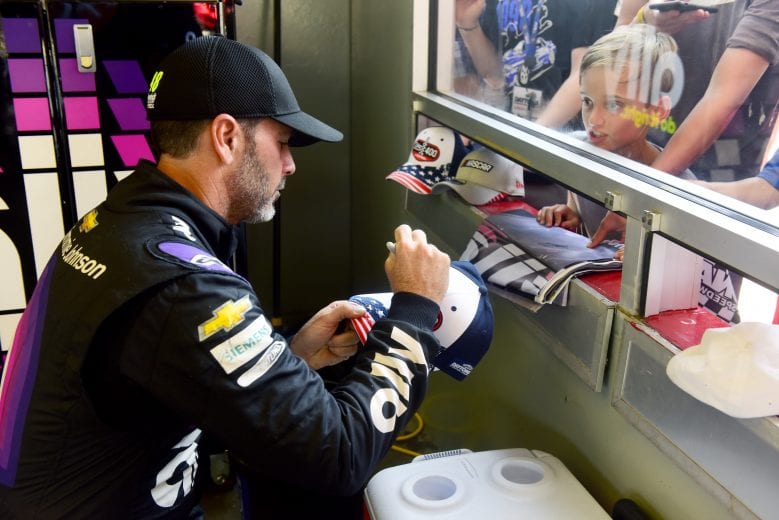 DAYTONA BEACH, FLORIDA - JULY 04: Jimmie Johnson, driver of the #48 Ally Chevrolet, signs autographs for fans in the garage area during practice for the Monster Energy NASCAR Cup Series Coke Zero Sugar 400 at Daytona International Speedway on July 04, 2019 in Daytona Beach, Florida. (Photo by Jared C. Tilton/Getty Images) | Getty Images