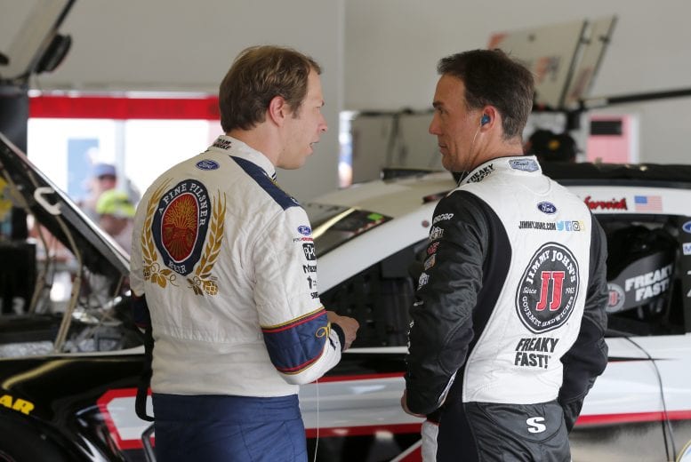 DAYTONA BEACH, FLORIDA - JULY 04: Brad Keselowski, driver of the #2 Miller Lite Ford, and, Kevin Harvick, driver of the #4 Jimmy John's Ford, talk in the garage area during practice for the Monster Energy NASCAR Cup Series Coke Zero Sugar 400 at Daytona International Speedway on July 04, 2019 in Daytona Beach, Florida. (Photo by Brian Lawdermilk/Getty Images) | Getty Images