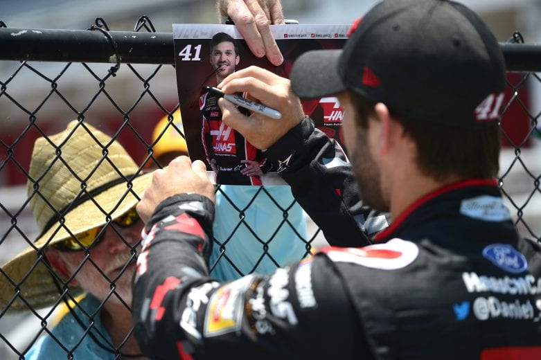 DAYTONA BEACH, FLORIDA - JULY 04: Daniel Suarez, driver of the #41 Haas Automation Ford, signs an autograph for a fan during practice for the Monster Energy NASCAR Cup Series Coke Zero Sugar 400 at Daytona International Speedway on July 04, 2019 in Daytona Beach, Florida. (Photo by Jeff Curry/Getty Images) | Getty Images