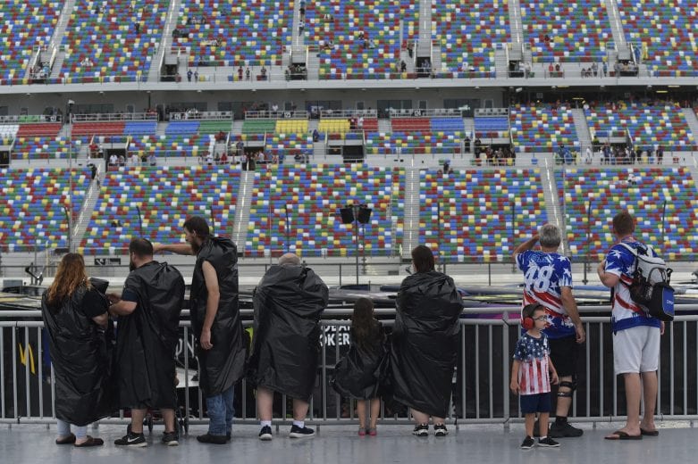 DAYTONA BEACH, FLORIDA - JULY 06: Fans wait out a rain delay near the garage during the Monster Energy NASCAR Cup Series Coke Zero Sugar 400 at Daytona International Speedway on July 06, 2019 in Daytona Beach, Florida. (Photo by Jeff Curry/Getty Images) | Getty Images