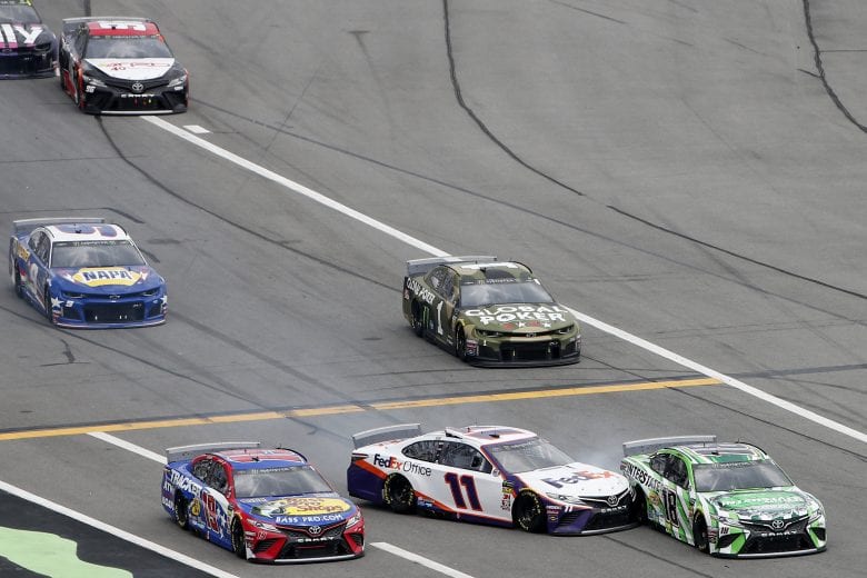 DAYTONA BEACH, FLORIDA - JULY 07: Martin Truex Jr., driver of the #19 BassProShops/TRACKER ATVs Toyota, Denny Hamlin, driver of the #11 FedEx Office Toyota, and Kyle Busch, driver of the #18 Interstate Batteries Toyota, drive down pit lane during the Monster Energy NASCAR Cup Series Coke Zero Sugar 400 at Daytona International Speedway on July 07, 2019 in Daytona Beach, Florida. (Photo by Brian Lawdermilk/Getty Images) | Getty Images