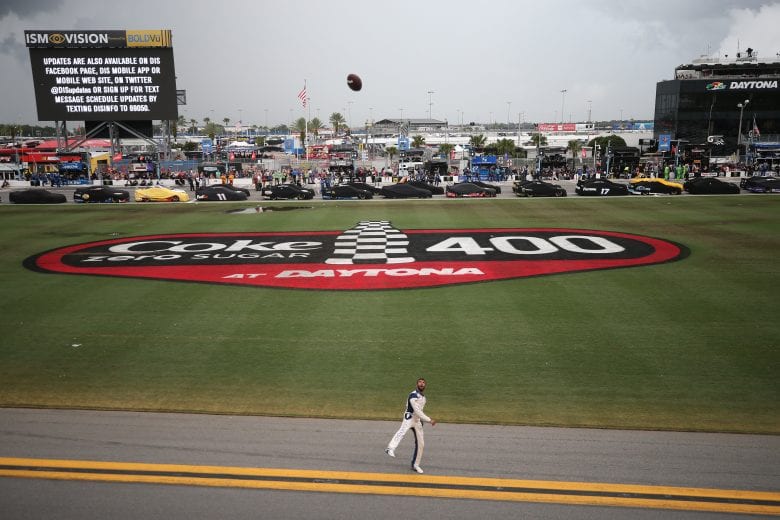 DAYTONA BEACH, FLORIDA - JULY 07: Bubba Wallace, driver of the #43 United States Air Force Chevrolet, throws a football to fans during a weather delay for the Monster Energy NASCAR Cup Series Coke Zero Sugar 400 at Daytona International Speedway on July 07, 2019 in Daytona Beach, Florida. (Photo by Matt Sullivan/Getty Images) | Getty Images