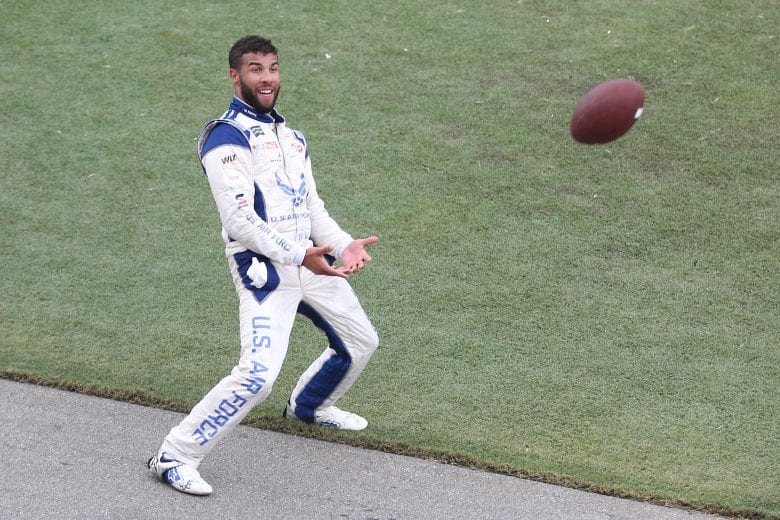 DAYTONA BEACH, FLORIDA - JULY 07: Bubba Wallace, driver of the #43 United States Air Force Chevrolet, plays with a football during a weather delay for the Monster Energy NASCAR Cup Series Coke Zero Sugar 400 at Daytona International Speedway on July 07, 2019 in Daytona Beach, Florida. (Photo by Matt Sullivan/Getty Images) | Getty Images