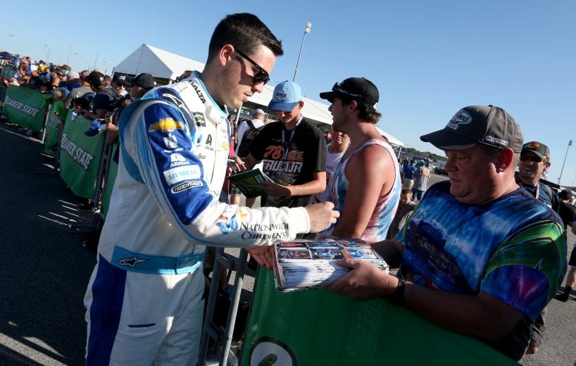 SPARTA, KENTUCKY - JULY 12: Alex Bowman, driver of the #88 Nationwide Children's Hospital Chevrolet, signs autographs during qualifying for the Monster Energy NASCAR Cup Series Quaker State 400 Presented by Walmart at Kentucky Speedway on July 12, 2019 in Sparta, Kentucky. (Photo by Brian Lawdermilk/Getty Images) | Getty Images