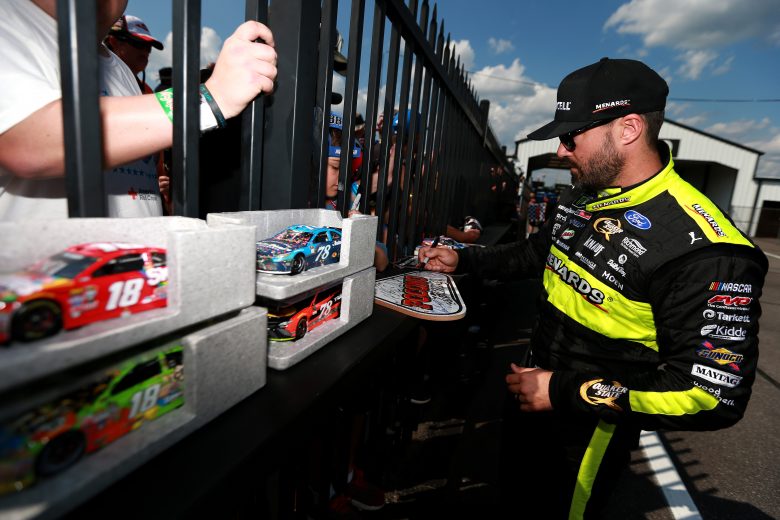 LONG POND, PENNSYLVANIA - JULY 27: Paul Menard, driver of the #21 Menards/Duracel Optimum Ford, signs autographs during qualifying for the Monster Energy NASCAR Cup Series Gander RV 400 at Pocono Raceway on July 27, 2019 in Long Pond, Pennsylvania. (Photo by Sean Gardner/Getty Images) | Getty Images