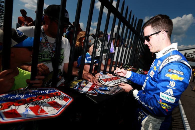 LONG POND, PENNSYLVANIA - JULY 27: Alex Bowman, driver of the #88 Nationwide Chevrolet, signs autographs during qualifying for the Monster Energy NASCAR Cup Series Gander RV 400 at Pocono Raceway on July 27, 2019 in Long Pond, Pennsylvania. (Photo by Sean Gardner/Getty Images) | Getty Images