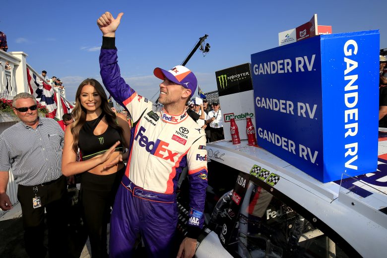 LONG POND, PENNSYLVANIA - JULY 28: Denny Hamlin, driver of the #11 FedEx Ground Toyota, celebrates in Victor Lane after winning the Monster Energy NASCAR Cup Series Gander RV 400 at Pocono Raceway on July 28, 2019 in Long Pond, Pennsylvania. (Photo by Chris Trotman/Getty Images) | Getty Images