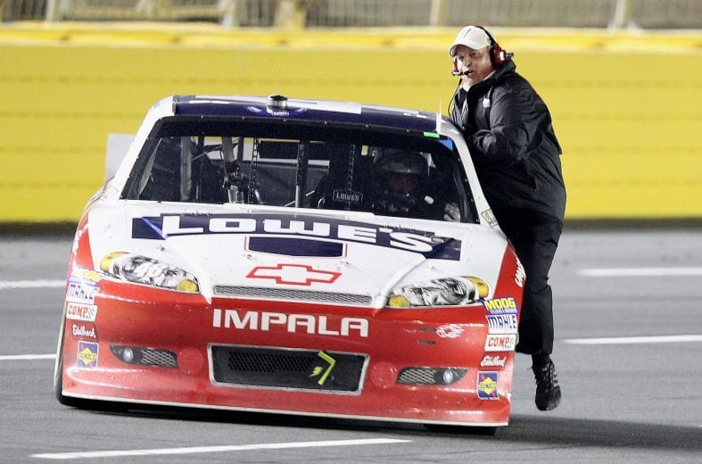 CHARLOTTE, NC - MAY 19: Jimmie Johnson, driver of the #48 Lowe's Patriotic Chevrolet, celebrates by doing a victory lap with team owner Rick Hendrick sitting on the door after winning the NASCAR Sprint All-Star Race at Charlotte Motor Speedway on May 19, 2012 in Charlotte, North Carolina. (Photo by Scott Halleran/Getty Images for NASCAR) | Getty Images