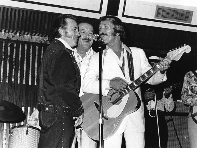 UNKNOWN — 1974: Country & Western music legend Marty Robbins (R) performs at one of his many concerts.  His musical accomplishments included a Grammy Award for his 1959 hit and signature song 