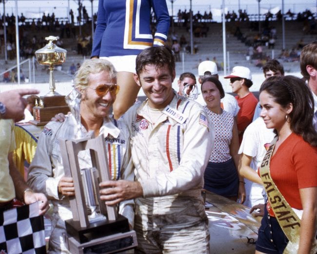 DARLINGTON, SC — September 6, 1971:  Marty Robbins (L) joins Bobby Allison in victory lane at Darlington Raceway after Allison won the Southern 500 NASCAR Cup race.  Country music entertainer Robbins, who dabbled in Cup racing off and on, had one of his best career finishes in the event, taking seventh place.  (Photo by ISC Images & Archives via Getty Images)