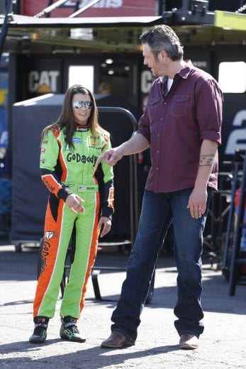 AVONDALE, AZ - MARCH 14:  Danica Patrick, driver of the #10 GoDaddy.com Chevrolet (left) and country music artist Blake Shelton (right) talk in the garage area during practice for the NASCAR Sprint Cup Series CampingWorld.com 500 at Phoenix International Raceway on March 14, 2015 in Avondale, Arizona.  (Photo by Christian Petersen/Getty Images) | Getty Images