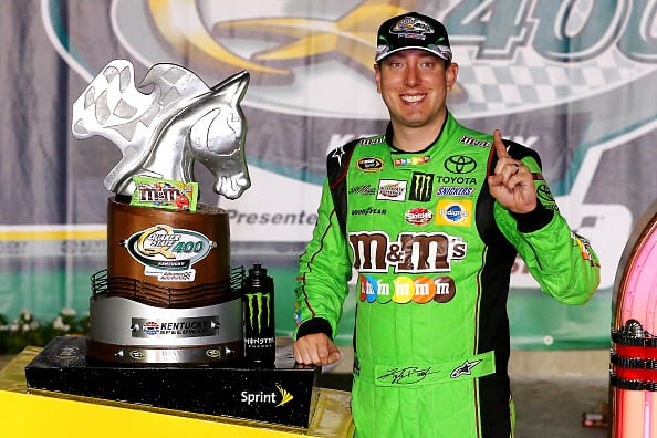 SPARTA, KY - JULY 11: Kyle Busch, driver of the #18 M&M's Crispy Toyota, poses with the winner's trophy in Victory Lane after winning the NASCAR Sprint Cup Series Quaker State 400 presented by Advance Auto Parts at Kentucky Speedway on July 11, 2015 in Sparta, Kentucky. (Photo by Sarah Crabill/Getty Images) | Getty Images
