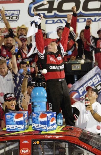 DAYTONA BEACH, FL - JULY 5:  Greg Biffle, driver of the #16 Ford Taurus, celebrates his victory in the Pepsi 400, on July 05, 2003 at Daytona International Speedway in Daytona Beach, Florida.  (Photo By Rusty Jarrett/Getty Images) | Getty Images