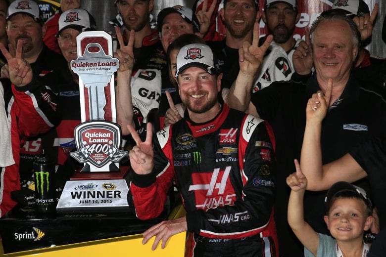 BROOKLYN, MI - JUNE 14: Kurt Busch, driver of the #41 Haas Automation Chevrolet, Gene Haas, co-owner of Stewart Haas Racing, and his team pose in an alternate Victory Lane after winning the NASCAR Sprint Cup Series Quicken Loans 400 at Michigan International Speedway on June 14, 2015 in Brooklyn, Michigan. (Photo by Chris Trotman/Getty Images) | Getty Images