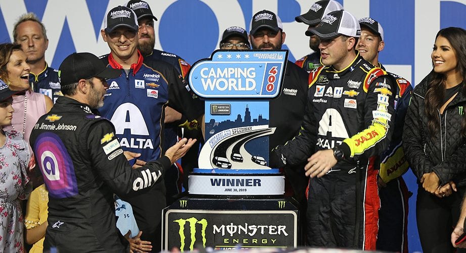 JOLIET, ILLINOIS - JUNE 30: Alex Bowman, driver of the #88 Axalta Chevrolet, talks with Jimmie Johnson, driver of the #48 Ally Chevrolet, after winning the Monster Energy NASCAR Cup Series Camping World 400 at Chicagoland Speedway on June 30, 2019 in Joliet, Illinois. (Photo by Matt Sullivan/Getty Images) | Getty Images
