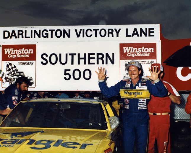 DARLINGTON, SC — September 6, 1987: Dale Earnhardt raises 10 fingers in the air in victory lane at Darlington Raceway after winning the Southern 500 NASCAR Cup race, his 10th Cup win of the year. Earnhardt would add one more victory to his total on his way to the NASCAR Cup title. During the year, Earnhardt finished either first or second in 16 of the 28 Cup races. Earnhardt’s Richard Childress Racing gasman Danny “Chocolate” Myers looks on at left. (Photo by ISC Images & Archives via Getty Images)