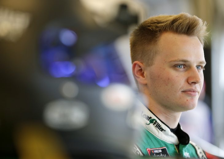 SPARTA, KENTUCKY - JULY 11: Justin Haley, driver of the #11 LeafFilter Gutter Protection Chevrolet, stands in the garage area during practice for the NASCAR Xfinity Series Alsco 300 at Kentucky Speedway on July 11, 2019 in Sparta, Kentucky. (Photo by Brian Lawdermilk/Getty Images)
