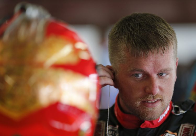 LOUDON, NEW HAMPSHIRE - JULY 19: Justin Allgaier, driver of the #7 BRANDT/Rev 1 Energy Chevrolet, stands in the garage area during practice for NASCAR Xfinity Series ROXOR 200 at New Hampshire Motor Speedway on July 19, 2019 in Loudon, New Hampshire. (Photo by Brian Lawdermilk/Getty Images) | Getty Images
