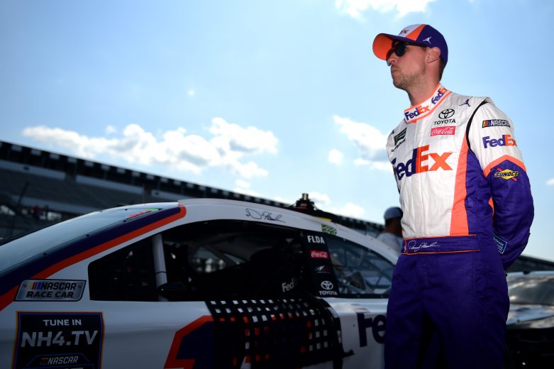 LONG POND, PENNSYLVANIA - JULY 27: Denny Hamlin, driver of the #11 FedEx Ground Toyota, walks on the grid during qualifying for the Monster Energy NASCAR Cup Series Gander RV 400 at Pocono Raceway on July 27, 2019 in Long Pond, Pennsylvania. (Photo by Jared C. Tilton/Getty Images) | Getty Images