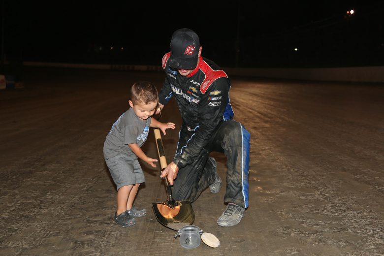ROSSBURG, OHIO - AUGUST 01: Stewart Friesen, driver of the #52 Halmar International Chevrolet, digs dirt from the track with his son, Parker, after winning the NASCAR Gander Outdoor Truck Series Eldora Dirt Derby at Eldora Speedway on August 01, 2019 in Rossburg, Ohio. (Photo by Matt Sullivan/Getty Images) | Getty Images
