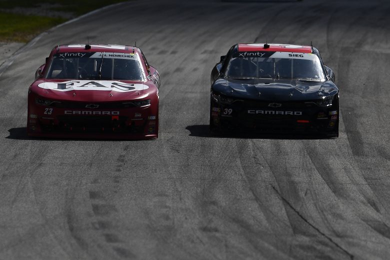 ELKHART LAKE, WISCONSIN - AUGUST 24: John Hunter Nemechek, driver of the #23 Fire Alarm Services Chevrolet, leads Ryan Sieg, driver of the #39 CMR Construction Chevrolet, during the NASCAR Xfinity Series CTECH Manufacturing 180 at Road America on August 24, 2019 in Elkhart Lake, Wisconsin. (Photo by Stacy Revere/Getty Images) | Getty Images