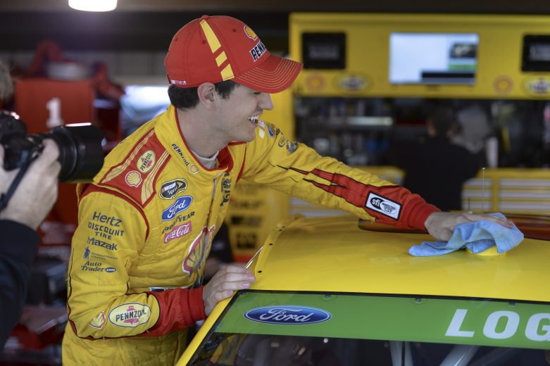 Joey Logano, driver of the #22 Shell-Pennzoil Ford, stands in the garage area during practice for the NASCAR Sprint Cup Series STP 500 at Martinsville Speedway on March 29, 2014 in Martinsville, Virginia.