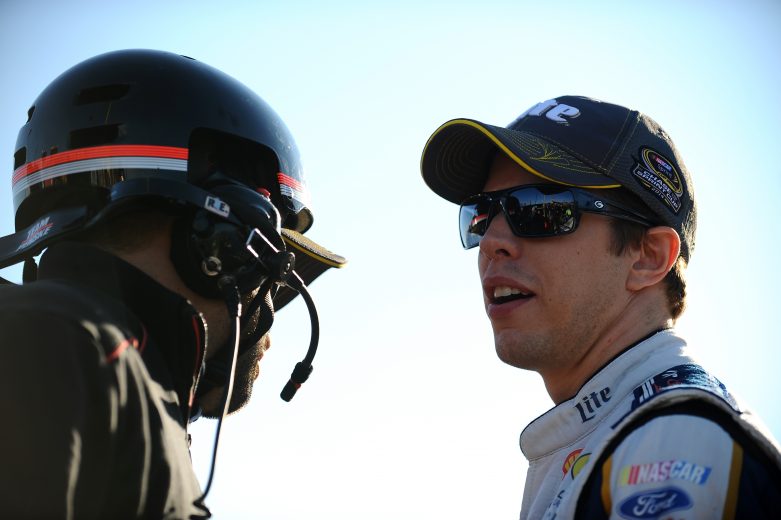 LOUDON, NH - SEPTEMBER 19:  Brad Keselowski, driver of the #2 Miller Lite Ford, speaks with a crew member during qualifying for the NASCAR Sprint Cup Series Sylvania 300 at New Hampshire Motor Speedway on September 19, 2014 in Loudon, New Hampshire.  (Photo by Will Schneekloth/Getty Images) | Getty Images
