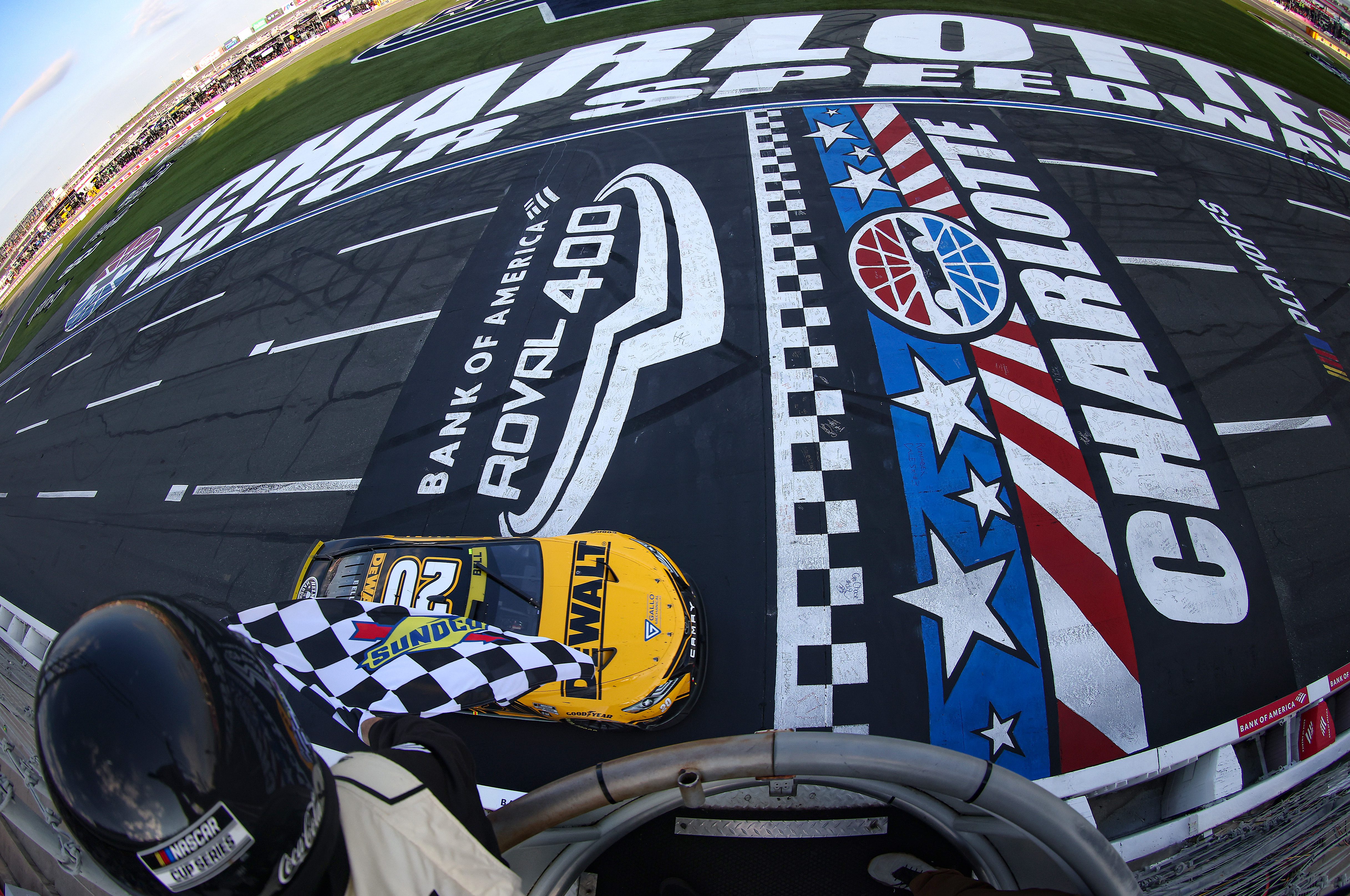 CONCORD, NORTH CAROLINA - OCTOBER 09: Christopher Bell, driver of the #20 DeWalt Toyota, takes the checkered flag to win the NASCAR Cup Series Bank of America Roval 400 at Charlotte Motor Speedway on October 09, 2022 in Concord, North Carolina. (Photo by Mike Mulholland/Getty Images) | Getty Images
