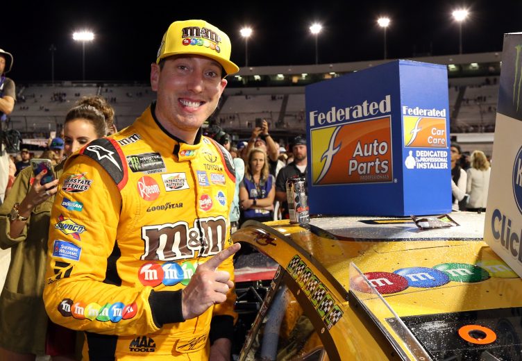 RICHMOND, VA - SEPTEMBER 22:  Kyle Busch, driver of the #18 M&M's Toyota, affixes the winners decal to his car in Victory Lane after winning the Monster Energy NASCAR Cup Series Federated Auto Parts 400 at Richmond Raceway on September 22, 2018 in Richmond, Virginia.  (Photo by Brian Lawdermilk/Getty Images) | Getty Images