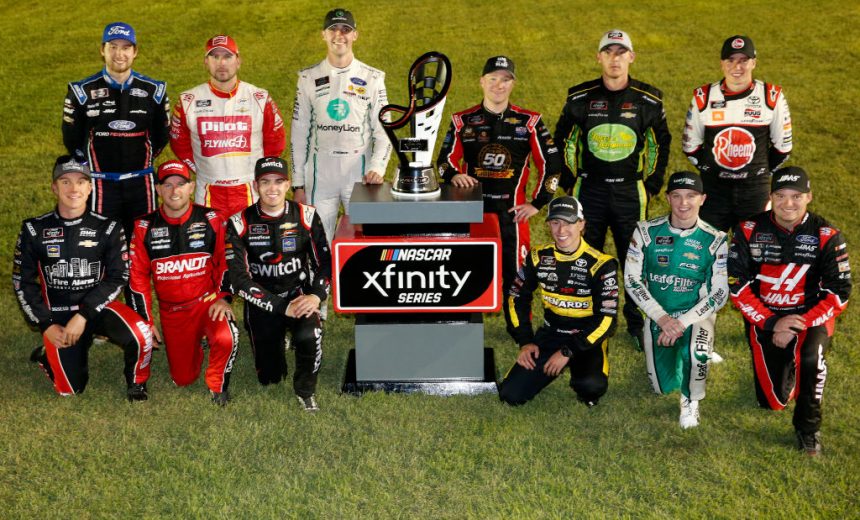 LAS VEGAS, NEVADA - SEPTEMBER 14: John Hunter Nemechek, driver of the #23 Berry's Manufacturing Chevrolet, Justin Allgaier, driver of the #7 BRANDT Professional Agriculture Chevrolet, Noah Gragson, driver of the #9 Switch Chevrolet, Brandon Jones, driver of the #19 Juniper Toyota, Justin Haley, driver of the #11 LeafFilter Gutter Protection Chevrolet, Cole Custer, driver of the #00 Haas Automation Ford, Chase Briscoe, driver of the #98 Ford Performance Ford, Michael Annett, driver of the #1 Pilot/Flying J Chevrolet, Austin Cindric, driver of the #22 MoneyLion Ford, Tyler Reddick, driver of the #2 TAME the BEAST Chevrolet, Ryan Sieg, driver of the #39 RSS Racing Chevrolet, Christopher Bell, driver of the #20 Rheem/Smurfit Kappa Toyota, pose for a photo as the 16 playoff contenders following the NASCAR Xfinity Series Rhino Pro Trucks Outfitters 300 at Las Vegas Motor Speedway on September 14, 2019 in Las Vegas, Nevada. (Photo by Jonathan Ferrey/Getty Images) | Getty Images