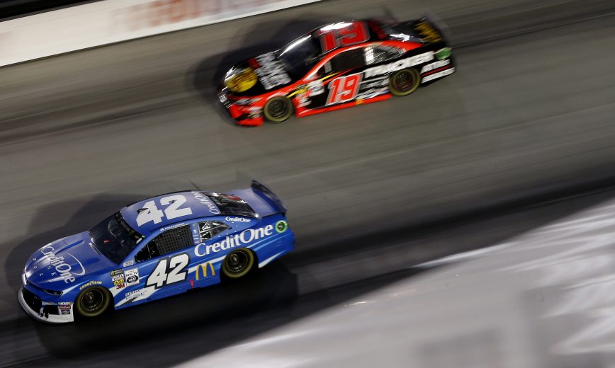 BRISTOL, TENNESSEE - AUGUST 17: Kyle Larson, driver of the #42 Credit One Bank Chevrolet, leads, Martin Truex Jr., driver of the #19 Bass Pro Shops/Tracker Off Road Toyota, during the Monster Energy NASCAR Cup Series Bass Pro Shops NRA Night Race at Bristol Motor Speedway on August 17, 2019 in Bristol, Tennessee. (Photo by Brian Lawdermilk/Getty Images) | Getty Images