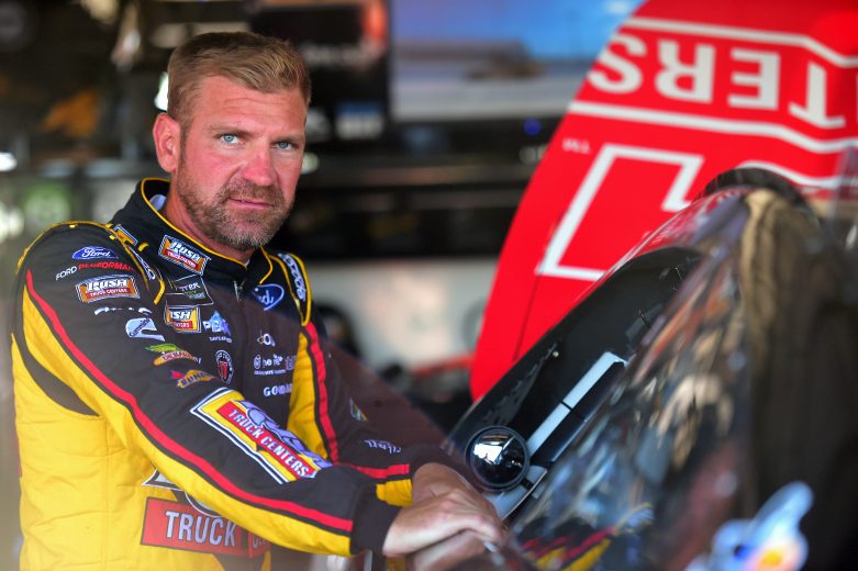 DARLINGTON, SOUTH CAROLINA - AUGUST 30: Clint Bowyer, driver of the #14 Rush Truck Centers/Mobil 1 Ford, stands in the garage area during practice for the Monster Energy NASCAR Cup Series Bojangles' Southern 500 at Darlington Raceway on August 30, 2019 in Darlington, South Carolina. (Photo by Jared C. Tilton/Getty Images) | Getty Images
