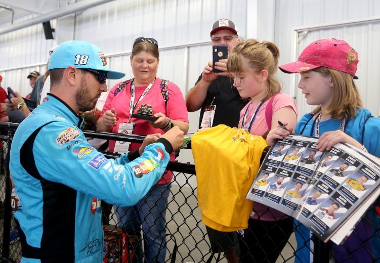RICHMOND, VIRGINIA - SEPTEMBER 20: Kyle Busch, driver of the #18 M&M's Hazelnut Toyota, signs autographs during practice for the Monster Energy NASCAR Cup Series Federated Auto Parts 400 at Richmond Raceway on September 20, 2019 in Richmond, Virginia. (Photo by Brian Lawdermilk/Getty Images) | Getty Images