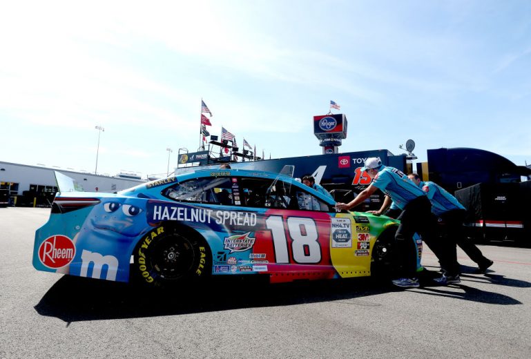 RICHMOND, VIRGINIA - SEPTEMBER 20: The crew of Kyle Busch, driver of the #18 M&M's Hazelnut Toyota, push the car during practice for the Monster Energy NASCAR Cup Series Federated Auto Parts 400 at Richmond Raceway on September 20, 2019 in Richmond, Virginia. (Photo by Brian Lawdermilk/Getty Images) | Getty Images