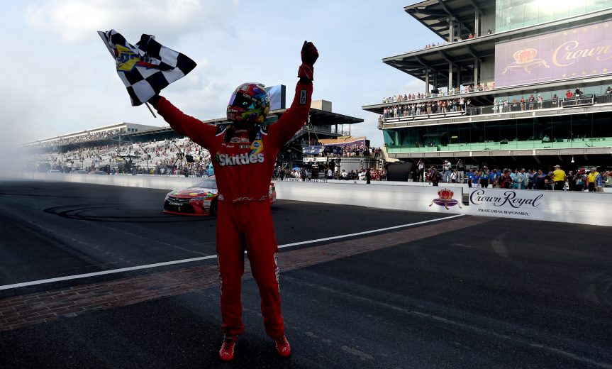 INDIANAPOLIS, IN - JULY 24:  Kyle Busch, driver of the #18 Skittles Toyota, celebrates winning the NASCAR Sprint Cup Series Crown Royal Presents the Combat Wounded Coalition 400 at Indianapolis Motor Speedway on July 24, 2016 in Indianapolis, Indiana.  (Photo by Bobby Ellis/Getty Images) | Getty Images