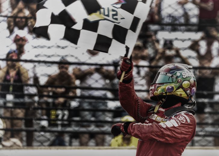 INDIANAPOLIS, IN - JUL 24: (EDITORS NOTE: This image was processed using digital filters) Kyle Busch, driver of the #18 Skittles Toyota waves the checkered flag after wining the Brickyard 400 at the Indianapolis Motor Speedway on July 24, 2016 in Indianapolis, Indiana. (Photo by Michael Hickey/Getty Images)