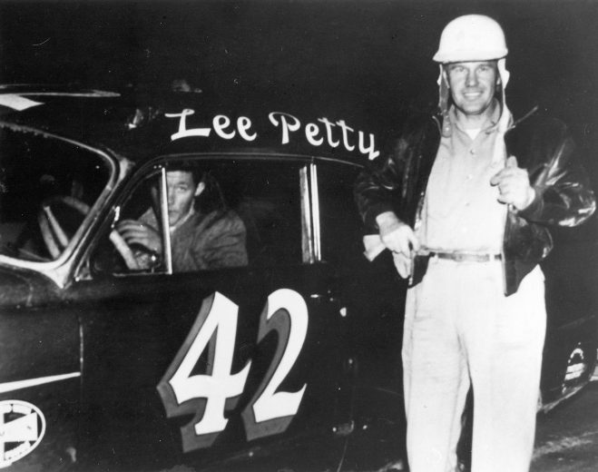 1953: Daddy Lee Petty stands by his car, with son Richard behind the wheel. Richard worked on his father's crew before he began driving, and was even ejected from the pits a time or two for being underage. (Photo by ISC Archives/CQ-Roll Call Group via Getty Images)