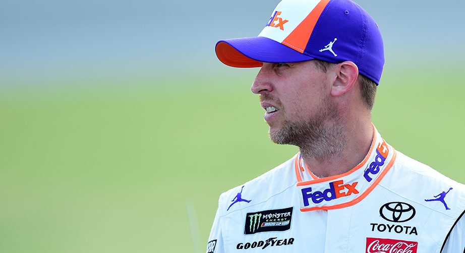JOLIET, ILLINOIS - JUNE 29: Denny Hamlin, driver of the #11 FedEx Express Toyota, stands on the grid during qualifying for the Monster Energy NASCAR Cup Series Camping World 400 at Chicagoland Speedway on June 29, 2019 in Joliet, Illinois. (Photo by Jared C. Tilton/Getty Images) | Getty Images