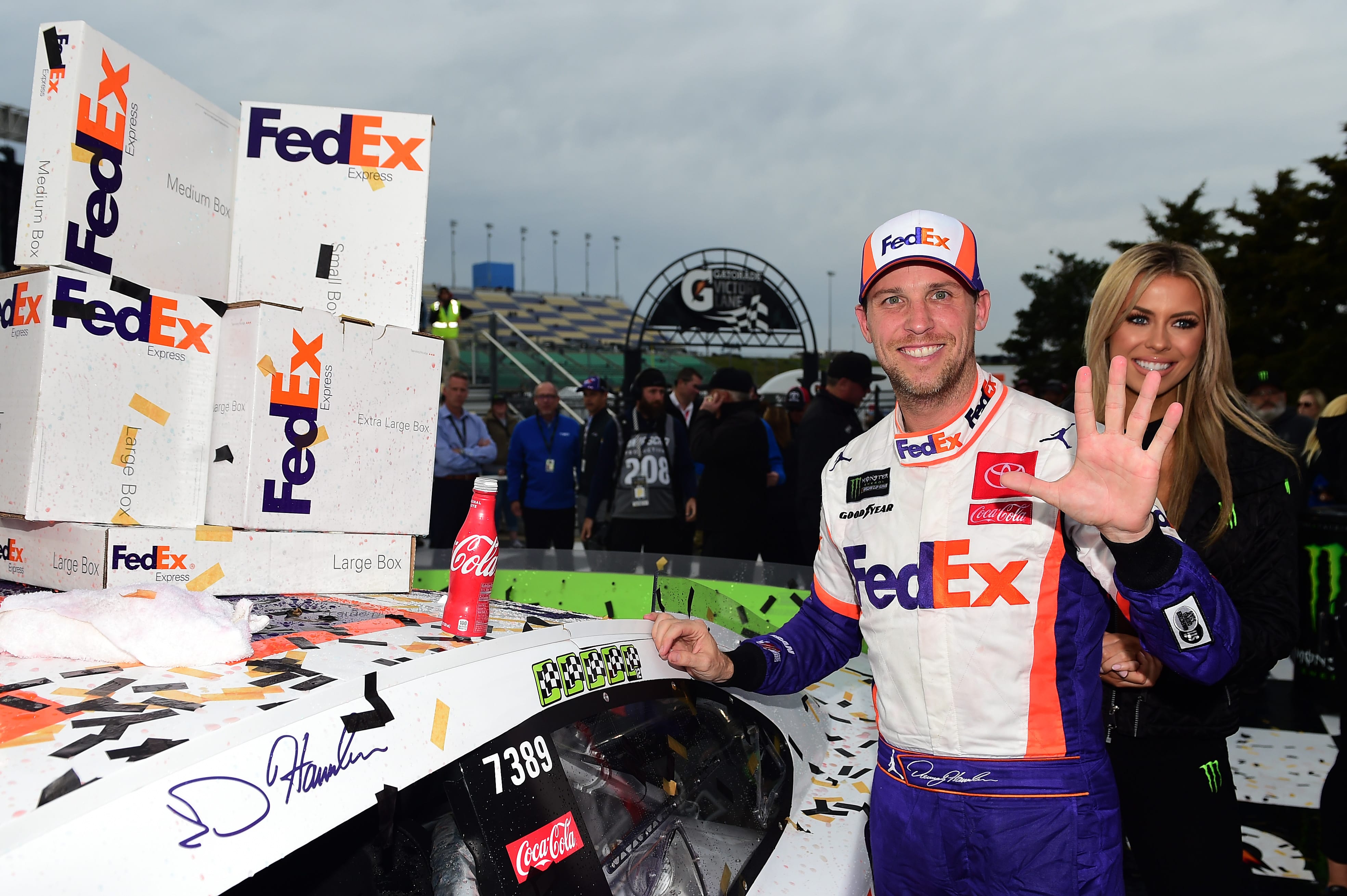 KANSAS CITY, KANSAS - OCTOBER 20: Denny Hamlin, driver of the #11 FedEx Office Toyota, poses with the winner's decal on his car in Victory Lane after winning the Monster Energy NASCAR Cup Series Hollywood Casino 400 at Kansas Speedway on October 20, 2019 in Kansas City, Kansas. (Photo by Jared C. Tilton/Getty Images) | Getty Images